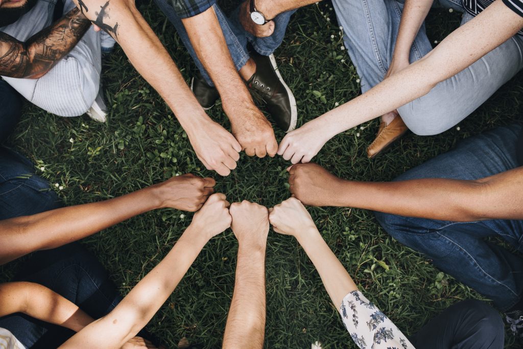 Diverse community with hands in a circle